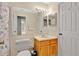 Well-lit bathroom features neutral walls, oak vanity, and coordinated coral seashell accents at 900 Northern Dancer Way # 204, Casselberry, FL 32707