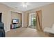 Cozy bedroom with a ceiling fan and sliding glass doors leading to an outdoor balcony at 900 Northern Dancer Way # 204, Casselberry, FL 32707