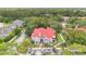 Charming grey condo with red roof, surrounded by mature trees, a parking lot, and a street at 900 Northern Dancer Way # 204, Casselberry, FL 32707