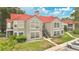 Multi-Gathering building with red tile roof and well-kept landscaping, offering a classic and inviting curb appeal at 900 Northern Dancer Way # 204, Casselberry, FL 32707