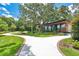 Beautiful community center with large windows, complemented by a well-manicured lawn and mature trees at 900 Northern Dancer Way # 204, Casselberry, FL 32707