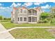Charming condo featuring a red tile roof, well-maintained lawn, and a screened porch, perfect for relaxing outdoors at 900 Northern Dancer Way # 204, Casselberry, FL 32707