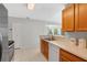 Bright kitchen featuring a double sink, modern appliances, and view to a sunroom at 900 Northern Dancer Way # 204, Casselberry, FL 32707
