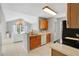 Well-lit kitchen with light wood cabinets, a breakfast bar, and an open view to the living room for easy entertaining at 900 Northern Dancer Way # 204, Casselberry, FL 32707