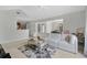 Open-concept living area with a view of the dining space and kitchen, featuring a white sofa and ample natural light at 900 Northern Dancer Way # 204, Casselberry, FL 32707