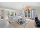 Bright and airy living room featuring large windows, a vaulted ceiling, and a comfortable white sofa at 900 Northern Dancer Way # 204, Casselberry, FL 32707