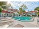 Exterior view of the inviting community pool and clubhouse with lounge chairs and palm trees at 900 Northern Dancer Way # 204, Casselberry, FL 32707