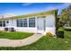 Well-kept condo exterior featuring a cozy front lawn, a variety of windows, and a welcoming entrance at 901 Illinois Ave, St Cloud, FL 34769