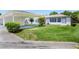 The house showcases a covered parking area, a well-manicured lawn and nice bushes at 901 Illinois Ave, St Cloud, FL 34769
