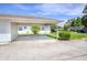 This lovely house has a covered parking area, with a view of a green front lawn at 901 Illinois Ave, St Cloud, FL 34769