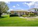 Well-maintained brick home featuring a lush lawn, colorful flowers, and lovely curb appeal at 901 Illinois Ave, St Cloud, FL 34769