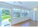 This is a bright sun room with white walls and a view of the lawn outside at 901 Illinois Ave, St Cloud, FL 34769