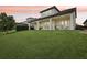 Back exterior of home featuring covered porch with serene backyard view at 9207 Busaco Park Way, Winter Garden, FL 34787