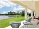 Relaxing back porch with outdoor seating overlooking serene lake views at 9207 Busaco Park Way, Winter Garden, FL 34787