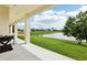 Scenic backyard view from the covered back porch overlooking the lake at 9207 Busaco Park Way, Winter Garden, FL 34787