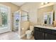 Well-lit bathroom with a walk-in shower, granite countertops, and modern fixtures, providing a comfortable and updated space at 9207 Busaco Park Way, Winter Garden, FL 34787
