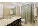 Practical bathroom with a vanity, shower, and floral shower curtain, perfect for everyday convenience at 9207 Busaco Park Way, Winter Garden, FL 34787