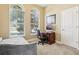 Cozy bedroom with two arched windows, a daybed, and a built-in desk, providing a comfortable and functional space at 9207 Busaco Park Way, Winter Garden, FL 34787