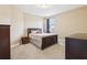 Comfortable bedroom with neutral walls, carpet, a window for natural light, and traditional furnishings at 9207 Busaco Park Way, Winter Garden, FL 34787
