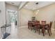 Formal dining room featuring tile floors, a wooden table set, and views into the living area at 9207 Busaco Park Way, Winter Garden, FL 34787