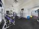 Bright fitness center with modern exercise equipment, ceiling fans and televisions in a light, airy room at 9207 Busaco Park Way, Winter Garden, FL 34787