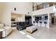 Spacious living room with a view of the kitchen, and a large balcony overlooking the space at 9207 Busaco Park Way, Winter Garden, FL 34787