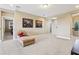 Spacious loft with neutral carpet, comfortable lounge seating, and tasteful artwork, creating a relaxing and inviting atmosphere at 9207 Busaco Park Way, Winter Garden, FL 34787