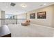 Cozy loft area with a comfortable lounge chair and views of the outdoors, perfect for relaxing or entertaining at 9207 Busaco Park Way, Winter Garden, FL 34787