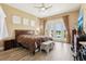 Spacious main bedroom with a ceiling fan and private access to a screened in patio overlooking the backyard pond at 9207 Busaco Park Way, Winter Garden, FL 34787