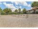 Community playground featuring multiple swings with a wood chip ground cover and palm tree accents at 9207 Busaco Park Way, Winter Garden, FL 34787