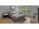 Cozy bedroom with a large window, neutral tones, and wood flooring at 976 Rock Harbor Ave, Orlando, FL 32828