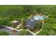Aerial view of a community center with a playground, pool, and parking lot surrounded by trees at 976 Rock Harbor Ave, Orlando, FL 32828