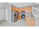 Functional kitchen with stainless steel appliances, ample cabinets and tiled floor at 976 Rock Harbor Ave, Orlando, FL 32828