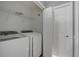 Laundry room with modern washer and dryer hookups and wire rack storage at 976 Rock Harbor Ave, Orlando, FL 32828
