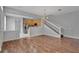 Inviting living space with hardwood floors, staircase access, and a view of the kitchen at 976 Rock Harbor Ave, Orlando, FL 32828