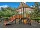 Community playground with shade, a slide, and stairs surrounded by a secure fence at 976 Rock Harbor Ave, Orlando, FL 32828