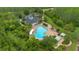 Aerial view of a community pool surrounded by lush landscaping, lounge chairs, and cabanas at 976 Rock Harbor Ave, Orlando, FL 32828