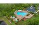 Aerial view of a community pool surrounded by lush landscaping and several lounge chairs at 976 Rock Harbor Ave, Orlando, FL 32828