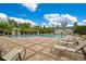 Relaxing community pool featuring lounge chairs and shaded seating areas on a sunny day at 976 Rock Harbor Ave, Orlando, FL 32828