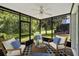 Enclosed sunroom with ceiling fan and backyard views at 976 Rock Harbor Ave, Orlando, FL 32828
