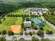 Aerial view of extensive community recreational facilities with tennis and basketball courts at 9966 Hidden Dunes Ln, Orlando, FL 32832