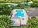 Aerial view of community pool, tennis courts, playground, and gathering area at 9966 Hidden Dunes Ln, Orlando, FL 32832