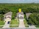 Aerial view of a charming two-story home with lush green lawn and landscaped garden at 9966 Hidden Dunes Ln, Orlando, FL 32832