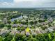 Beautiful aerial shot of the home in a lush neighborhood near a lake at 9966 Hidden Dunes Ln, Orlando, FL 32832