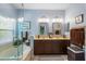 This bathroom features dual sinks, dual mirrors, a stand up shower, and a soaking tub at 9966 Hidden Dunes Ln, Orlando, FL 32832