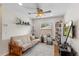 Bedroom with hardwood floors, ceiling fan, window, and an entertainment center at 9966 Hidden Dunes Ln, Orlando, FL 32832