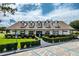 Community clubhouse featuring charming architecture, well maintained landscaping and ample parking at 9966 Hidden Dunes Ln, Orlando, FL 32832