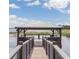 Picturesque waterfront dock with covered gazebo at 9966 Hidden Dunes Ln, Orlando, FL 32832