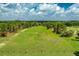 Aerial view of the golf course with lush green grass and mature trees at 9966 Hidden Dunes Ln, Orlando, FL 32832