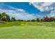 Beautifully manicured golf course featuring undulating greens and lush fairways at 9966 Hidden Dunes Ln, Orlando, FL 32832